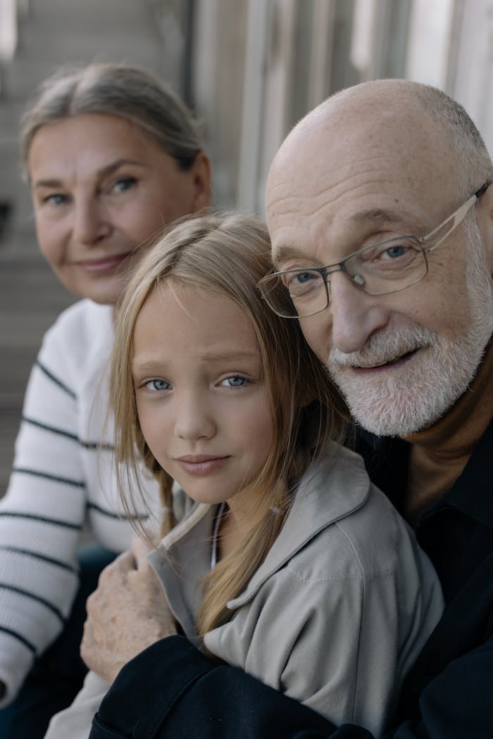 Close-up of a loving family moment with grandparents and grandchild embracing warmly.