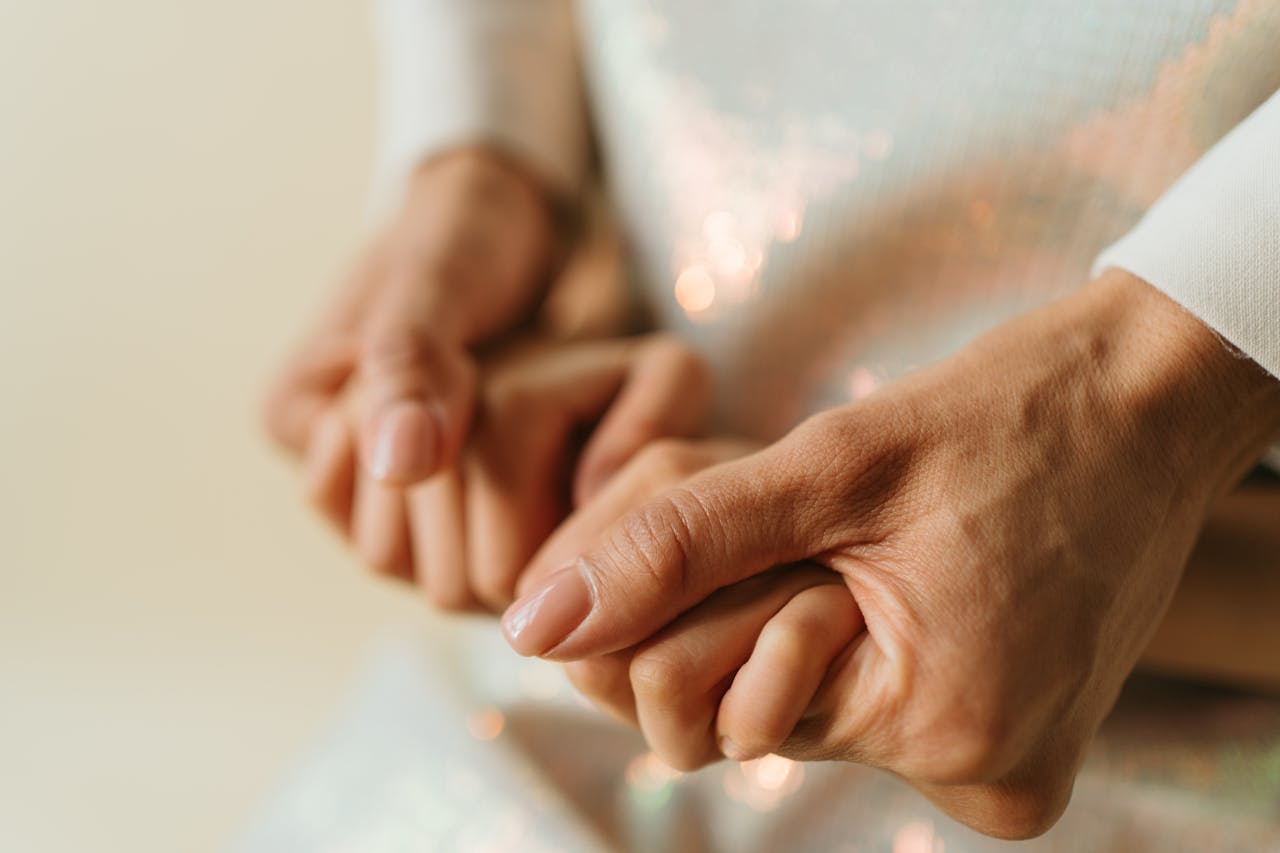 Close-up of two hands gently holding, symbolizing love and connection.